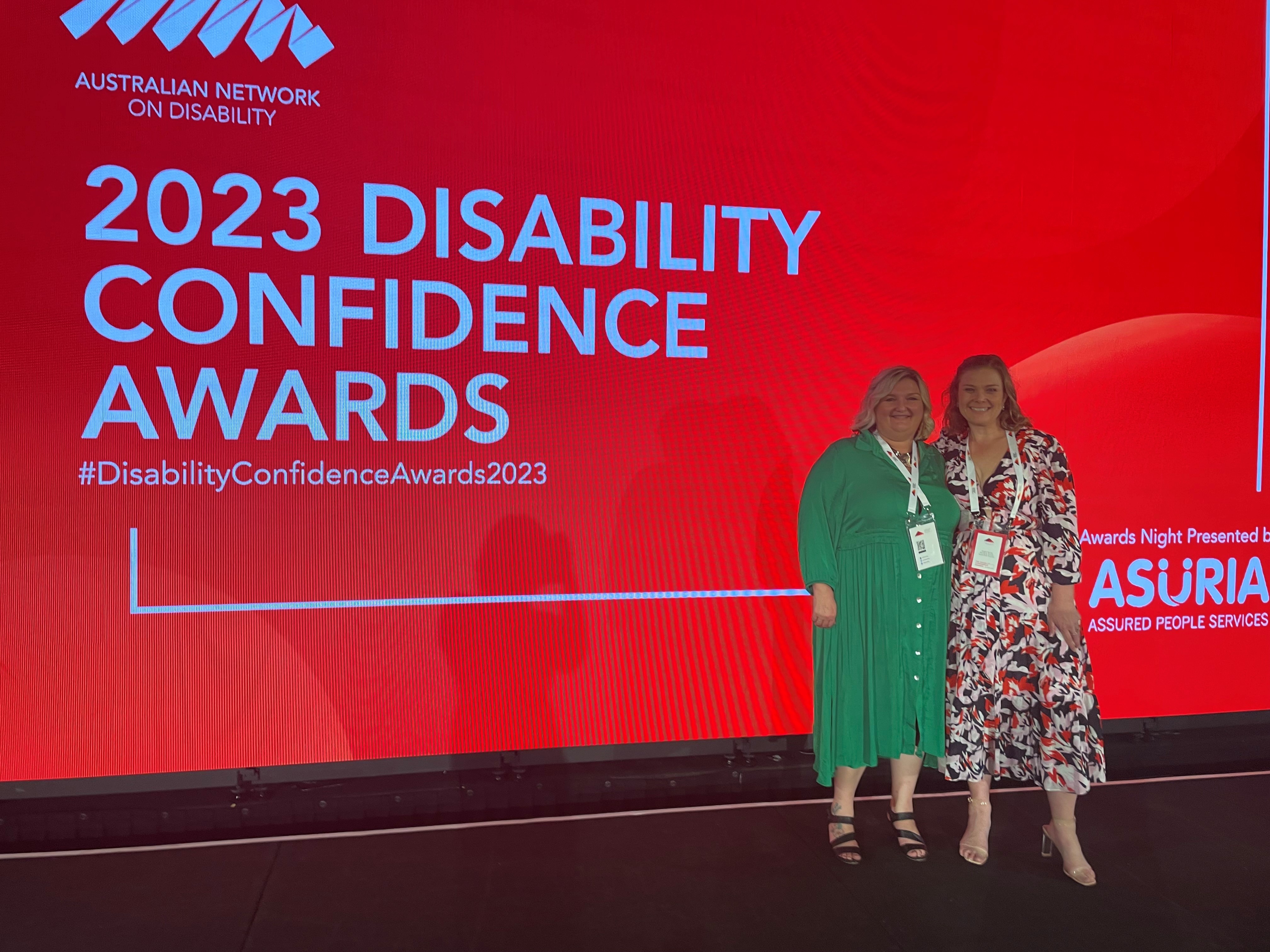 Two team members on stage at the 2023 Disability Confidence Awards, Australian Network on Disability